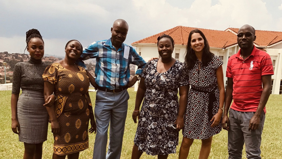 A group of people standing for a portrait outside in Uganda